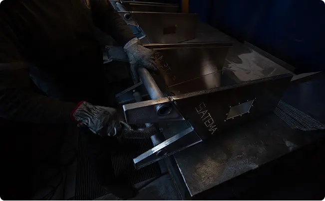 Skilled metalworker performing advanced fabrication on large aluminum components as part of expert welding solutions.