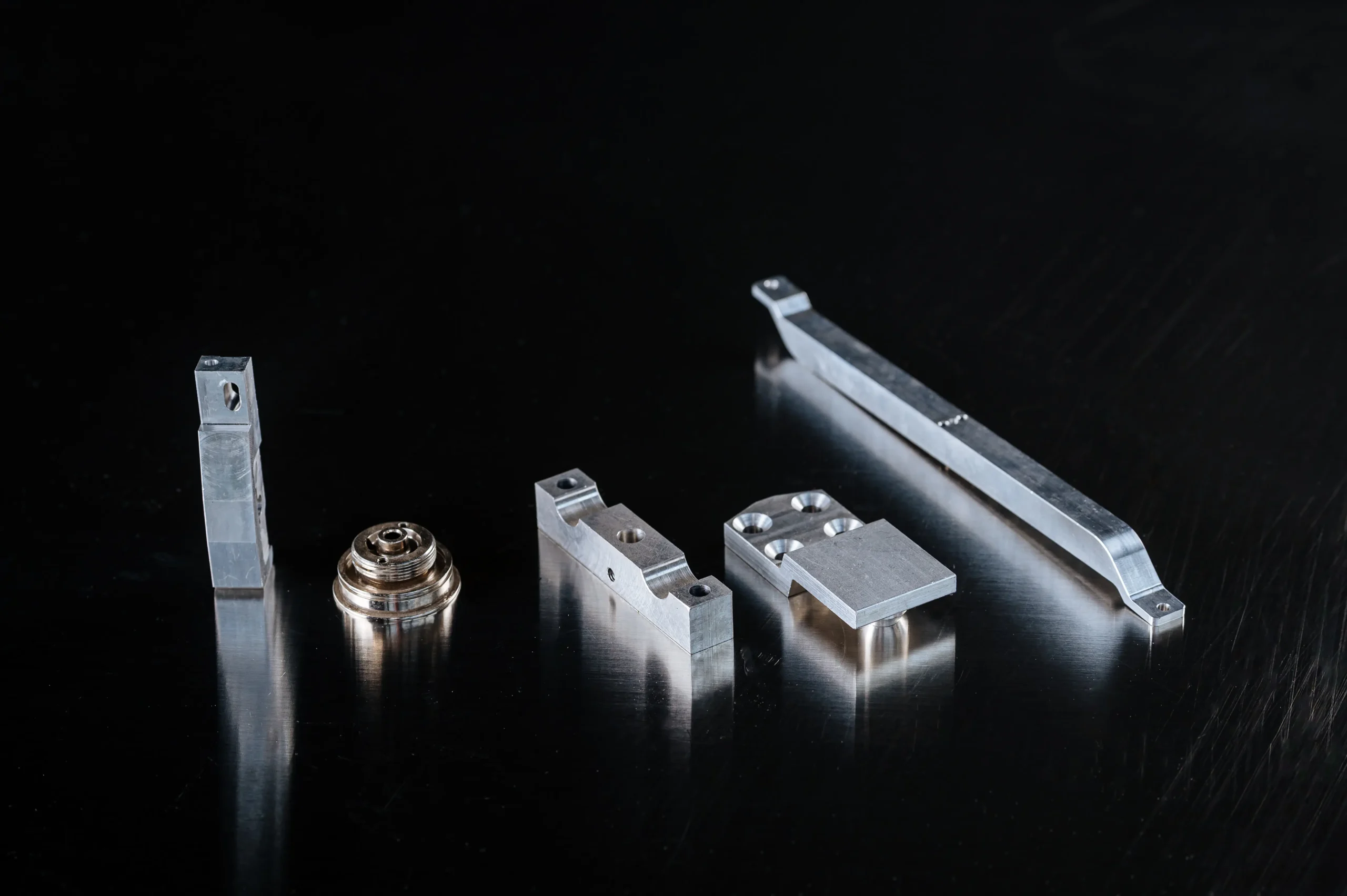 Precision CNC Turning & Milling components such as linear brackets and aluminum milled parts for mechanical assemblies by Teters