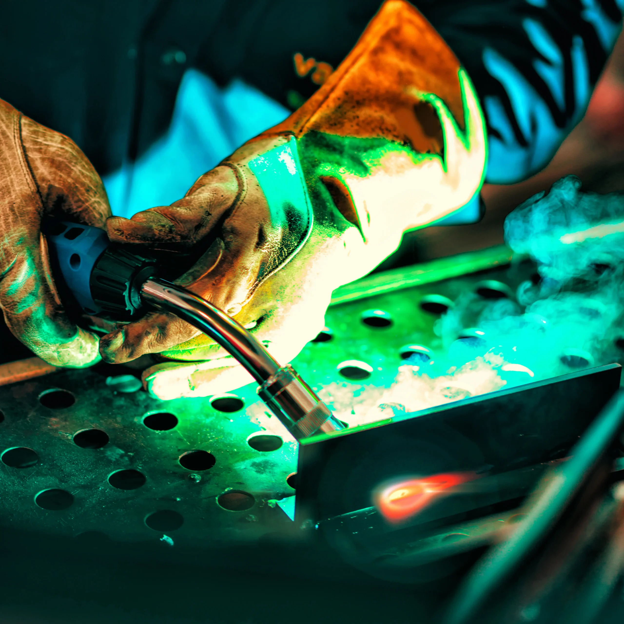 MIG welding torch in use during precision metal fabrication — showcasing expert industrial welding craftsmanship.
