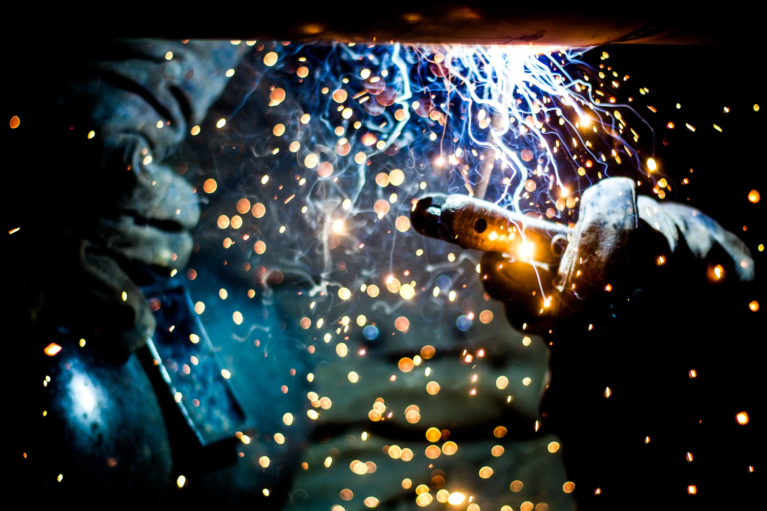 Intense arc welding process during industrial metalwork, demonstrating high-quality fabrication services.